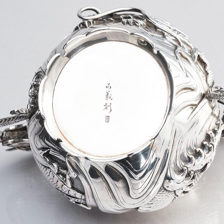 A three piece japanse silver 'dragon' tea set, Signed 三代目 大島, third generation Oshima, early 20th Century.