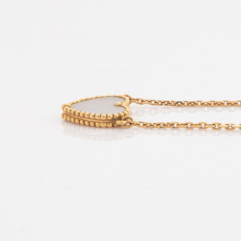 Van Cleef & Arpels, 18K gold and mother of pearl Alhambra heart necklace.