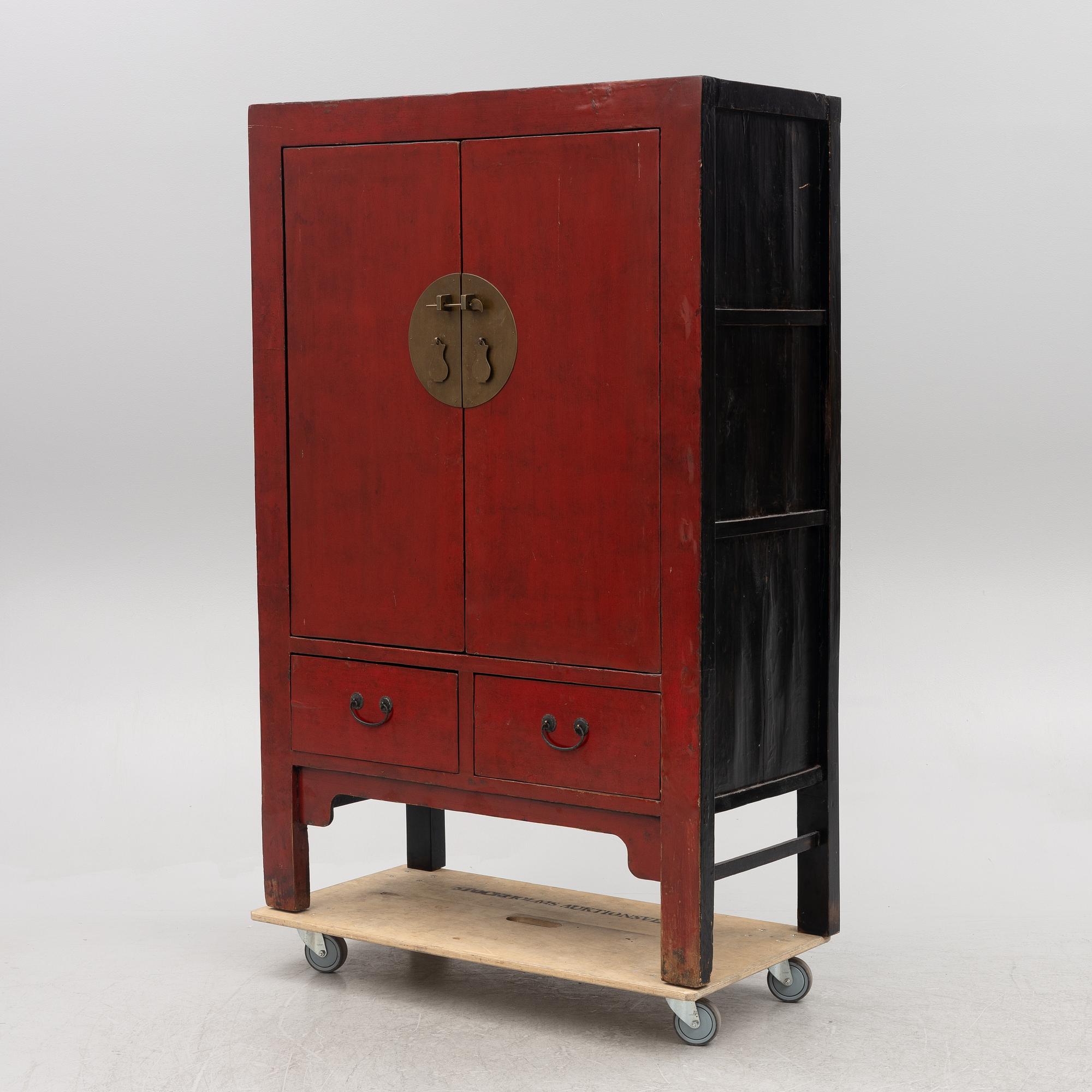 A red-lacquered cabinet, China, 20th century.