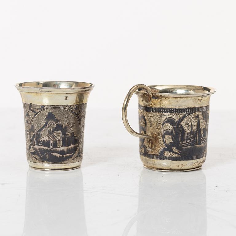Two Russian parcel-gilt silver niello vodka cups, Moscow 1832 and 1845.