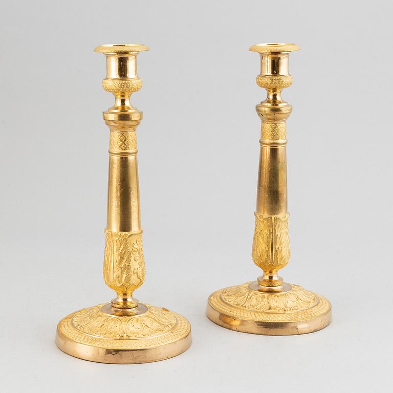 A pair of french gilt bronze candle holders, around 1820.