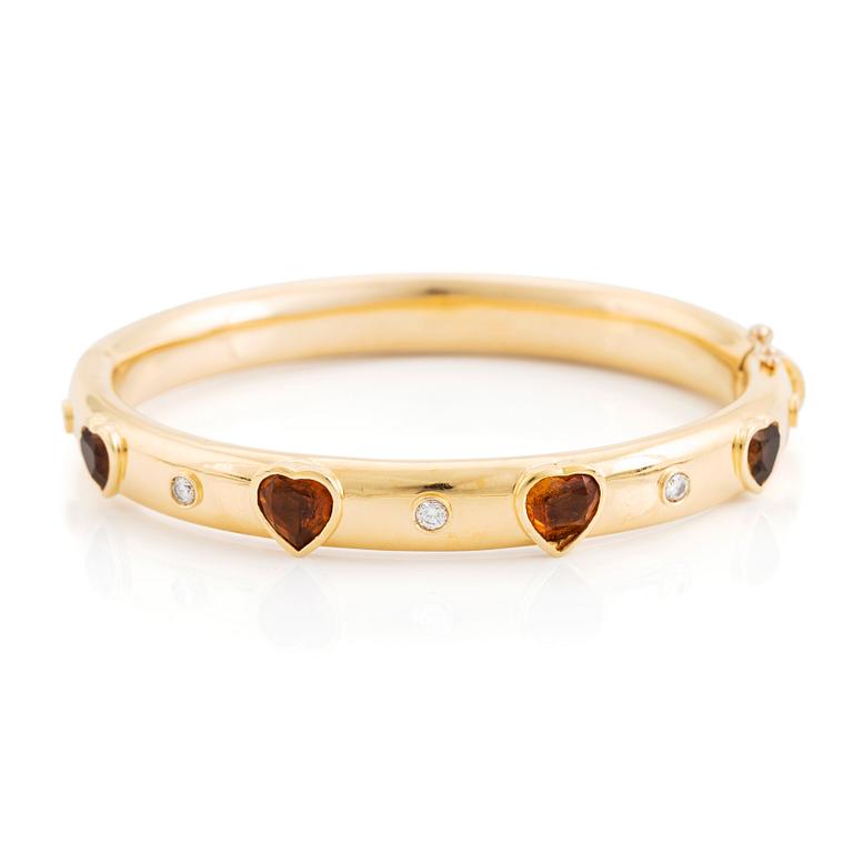 An 18K gold David Morris bangle set with citrines and round brilliant-cut diamonds.