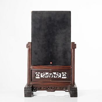 A Chinese lacquer table screen in a sculptured hardwood stand, 19th/20th Century.