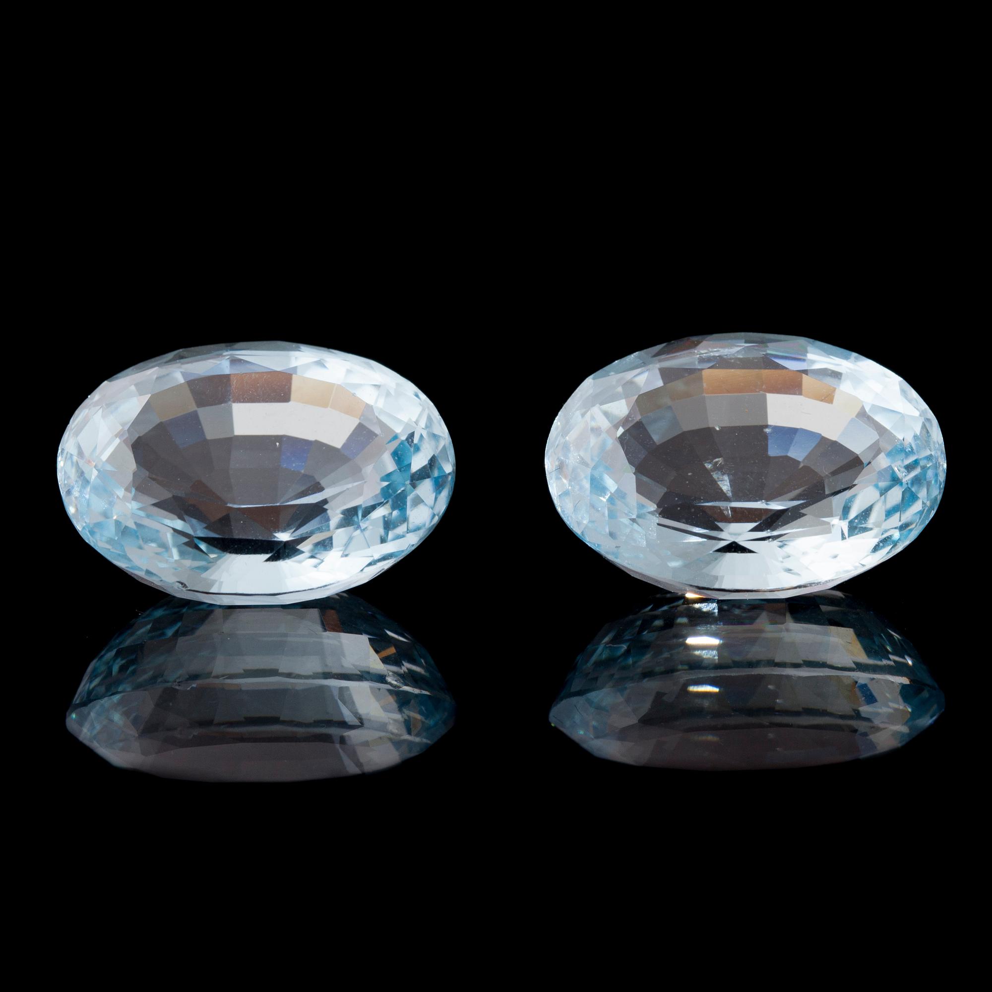 AKVAMARIN, 2 st, oval fasettslipning. Vikt totalt ca 26,93 ct.