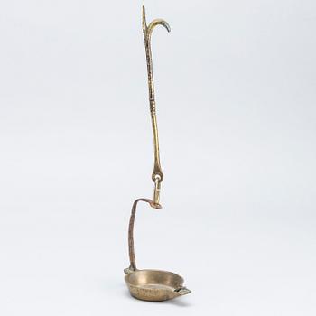 A 18th century oil lamp.