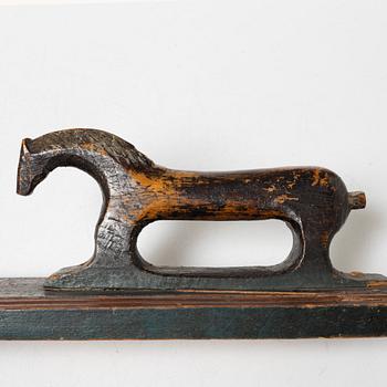 A painted wooden mangle board, dated 1831.