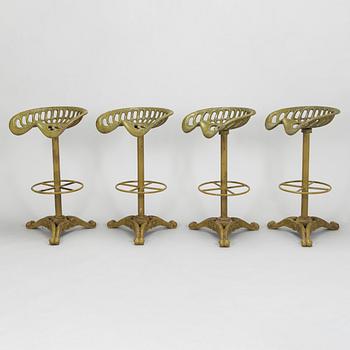 Four bar stools, painted cast iron, partly from the early 20th century.