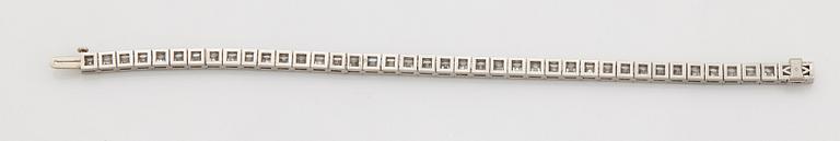 A platinum bracelet set with carré cut diamonds.