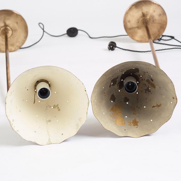 A pair of Swedish Modern brass uplights, 1940's.