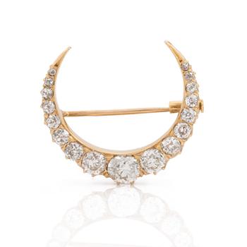 A gold and circa 2.85 ct old cut diamond crescent brooch. Probably late 1800s.