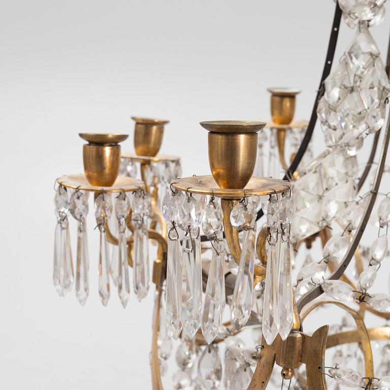 A Louis XVI gilt-brass and cut glass nine-light chandelier, circa 1800.