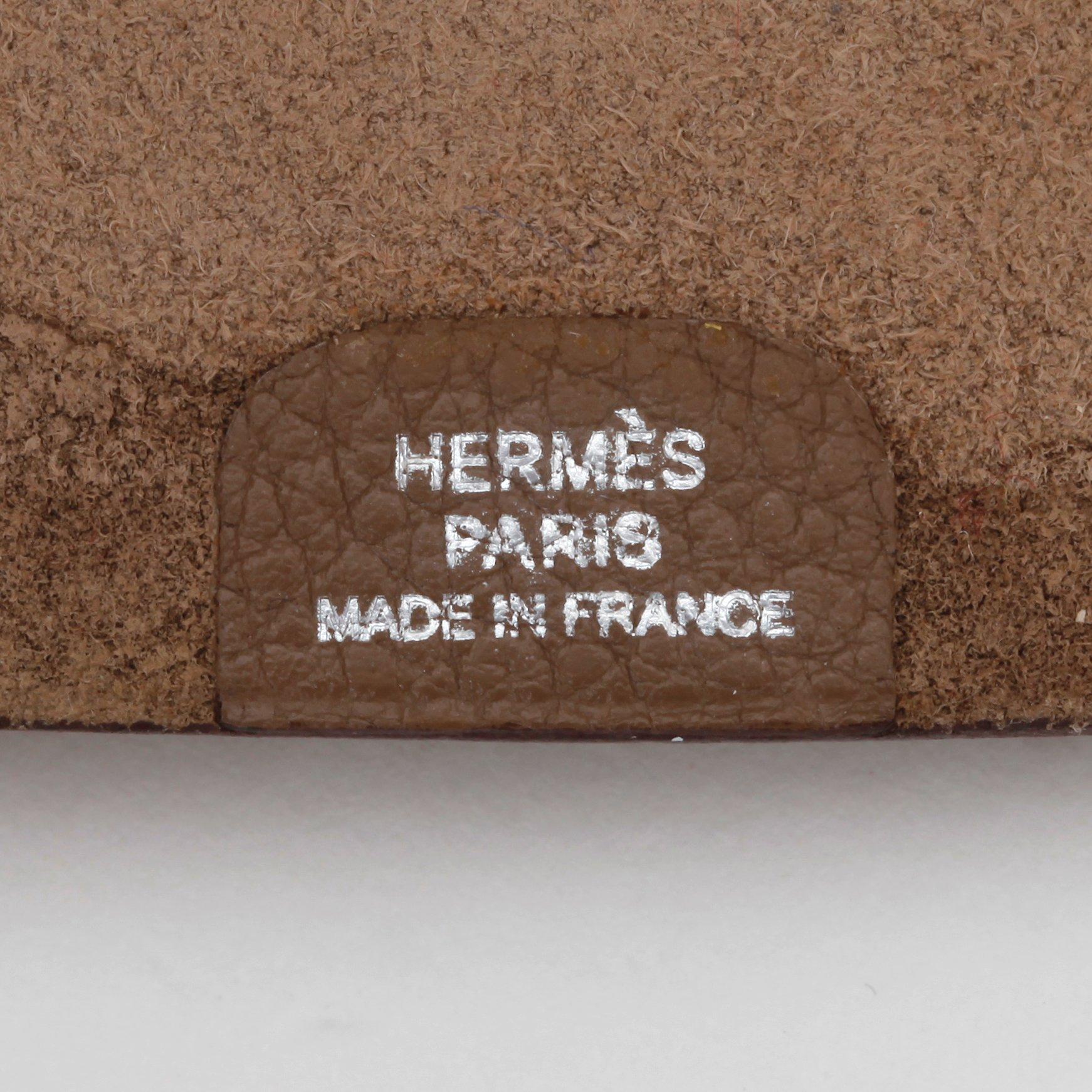 HERMÈS, a grey wallet and notebook cover, "Dogon" and "Ulysse".