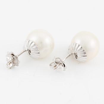 A pair of 18K gold earrings with cultured South Sea pearls.