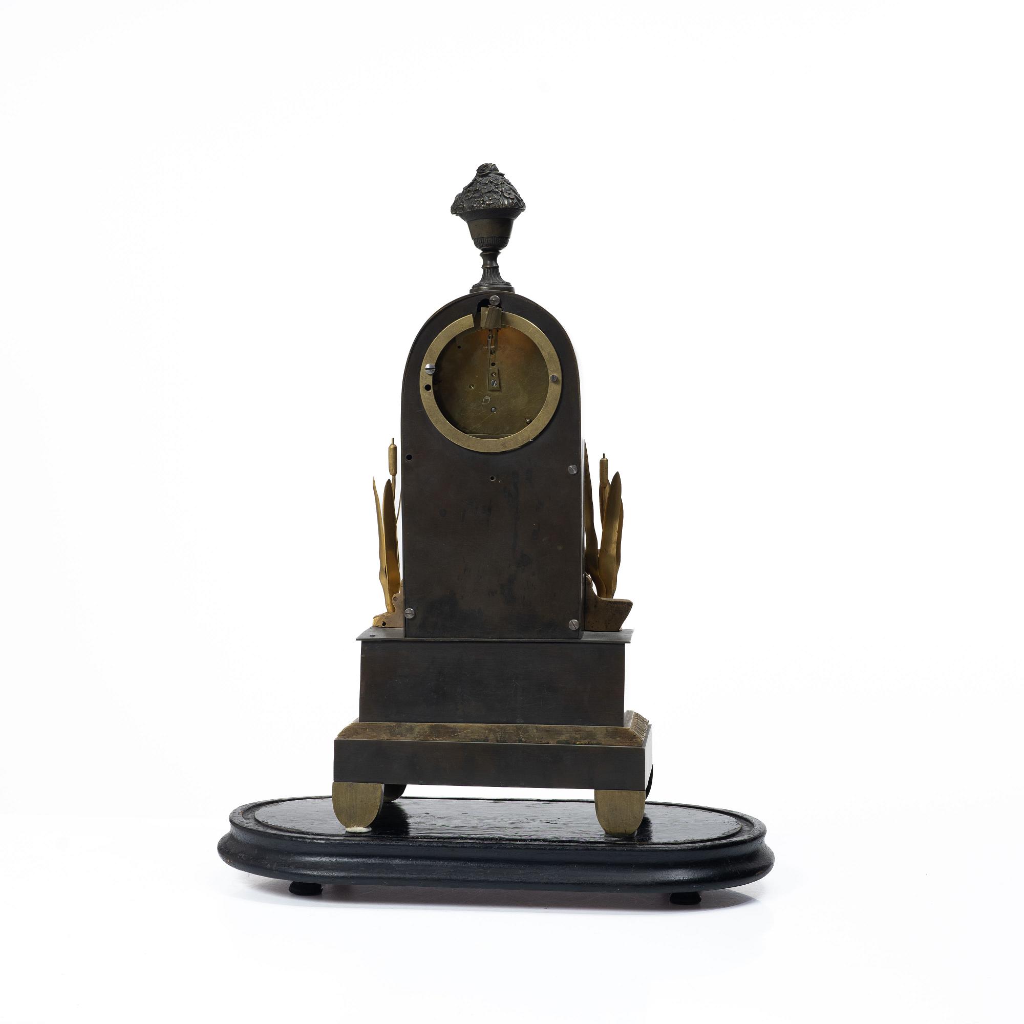 A French Charles X ormolu and patinated bronze mantel clock, ca 1820's.