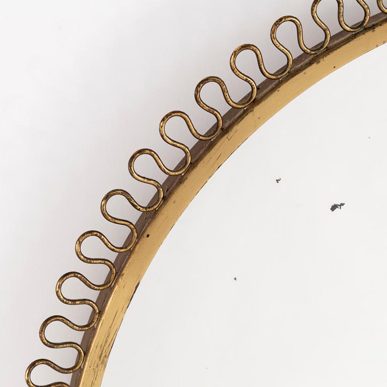 A mid 20th century brass frame mirror.