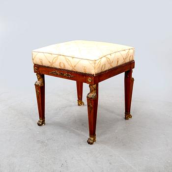 An Empire style mahogany stool around 1900.