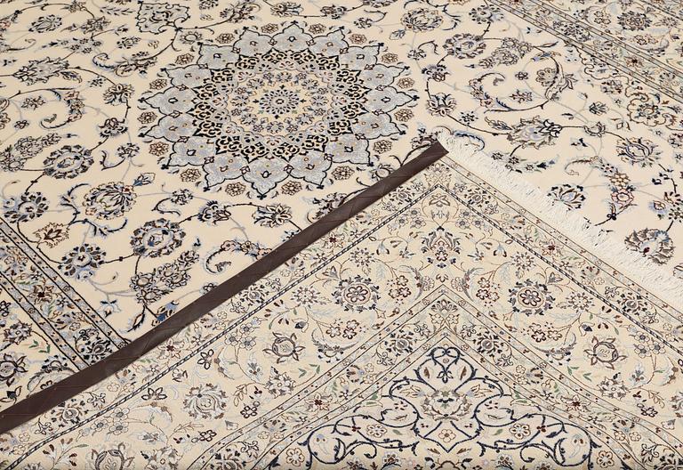 A Nain, part silk carpet, 305 x 207 cm.