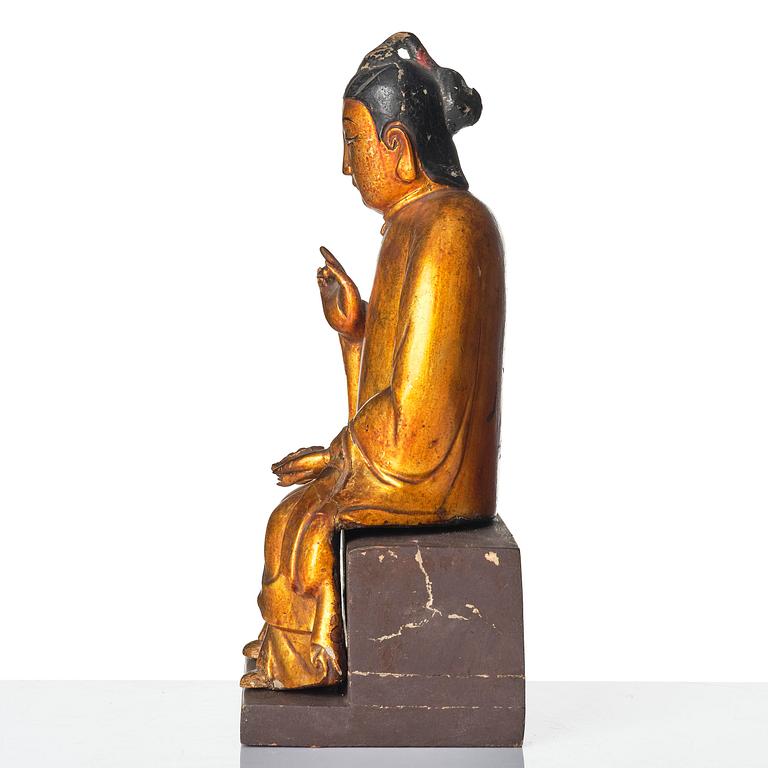 A gilt and polychrome lacquer figure of a divinity, 16th/17th century.