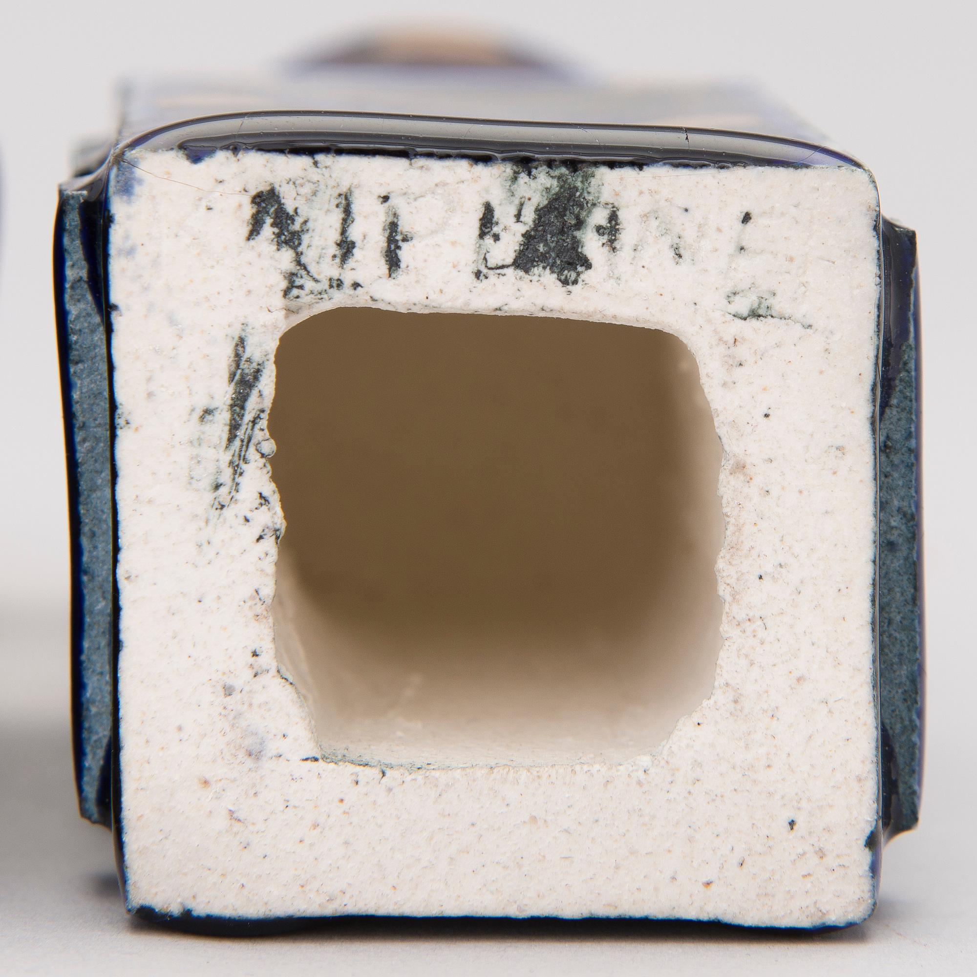 A pair of ceramic candlesticks signed Kaipiainen.