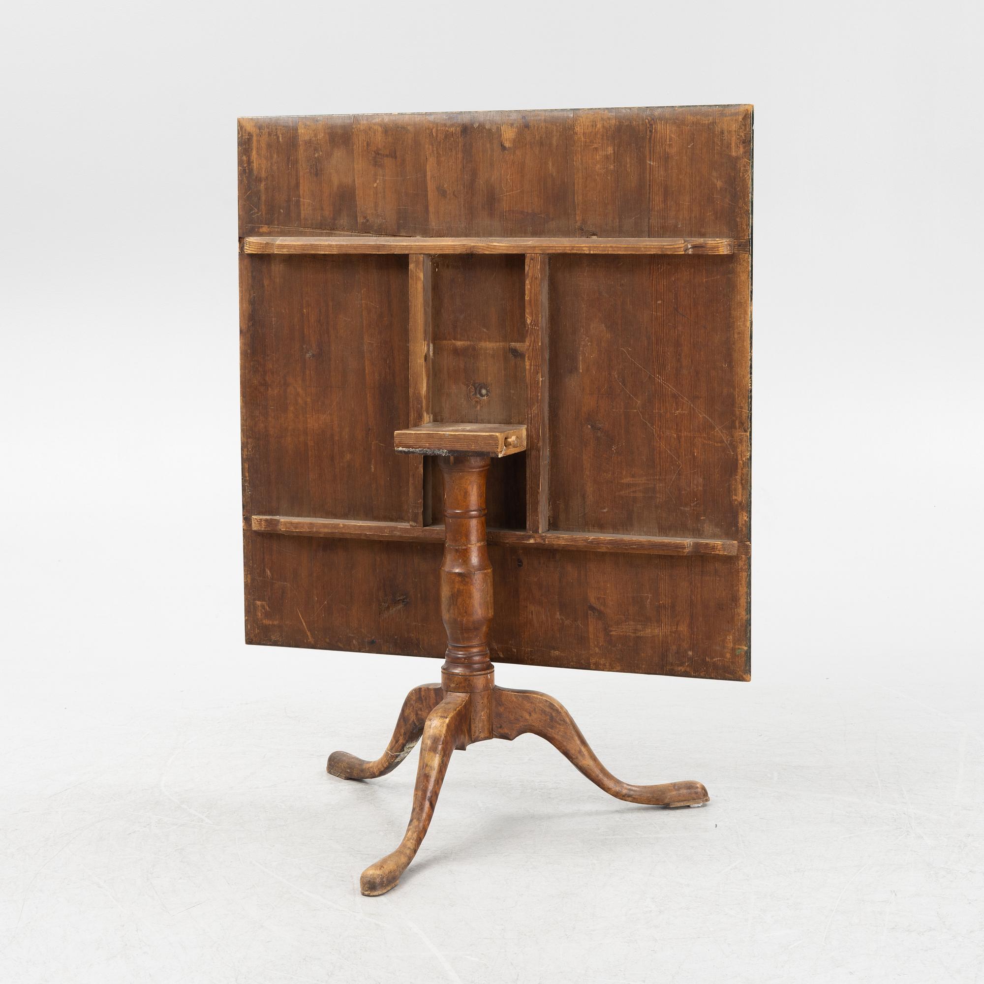 A root veneered tilt-top table, 19th Century.