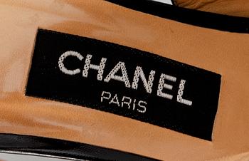 A pair of beige silk slingbacks by Chanel.