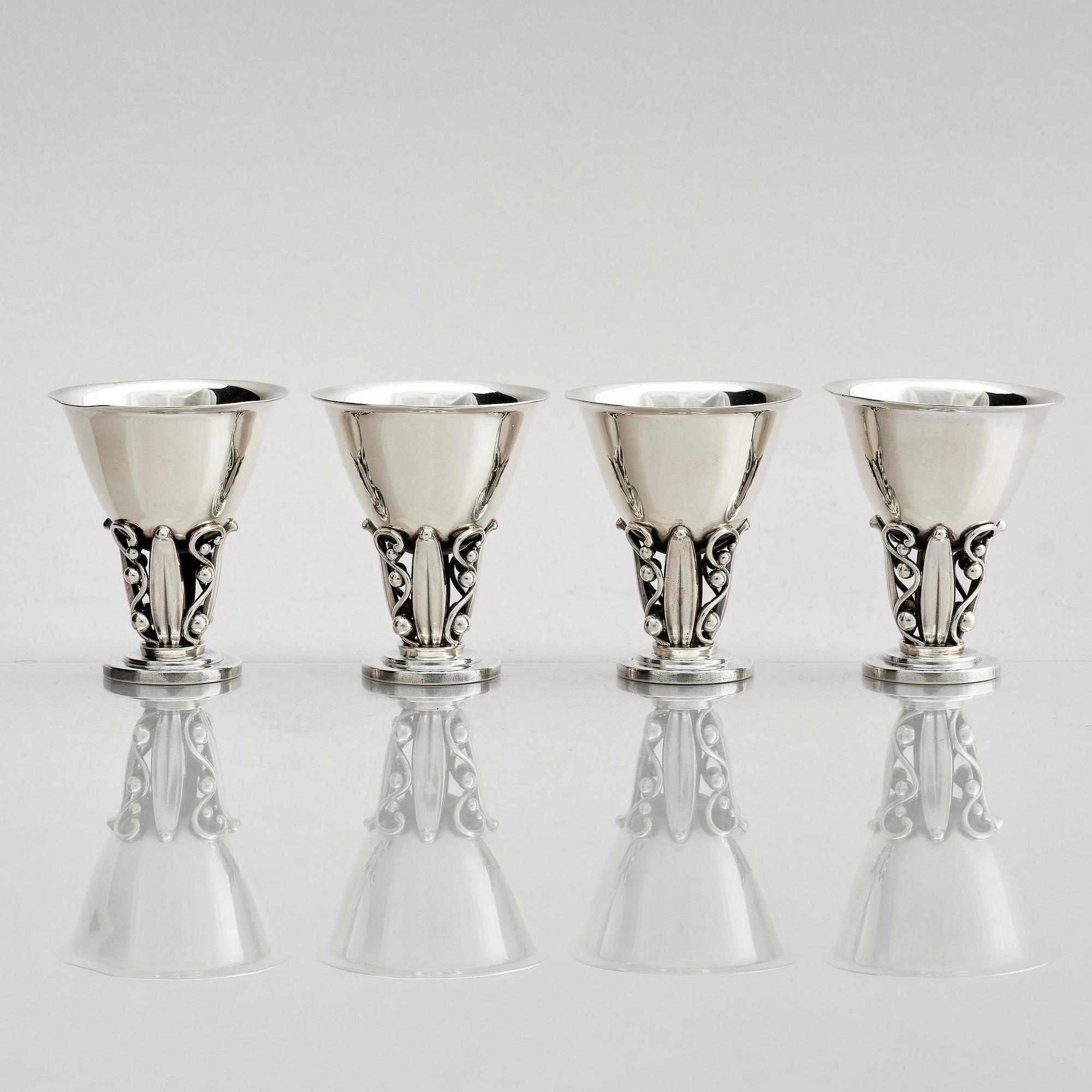 Evald Nielsen, four sterling silver beakers/cups on a foot, Denmark 20th century.
