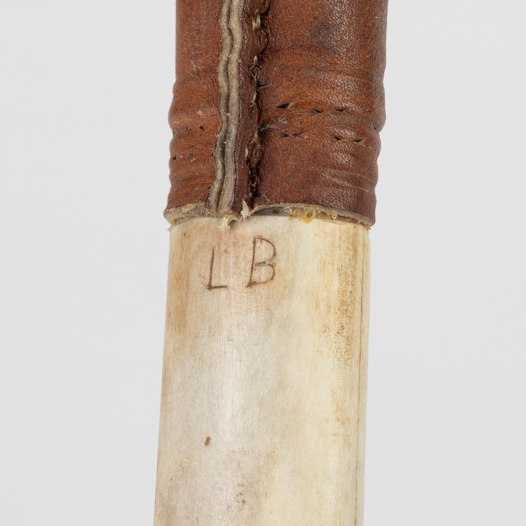 A reindeer horn knife signed LB.