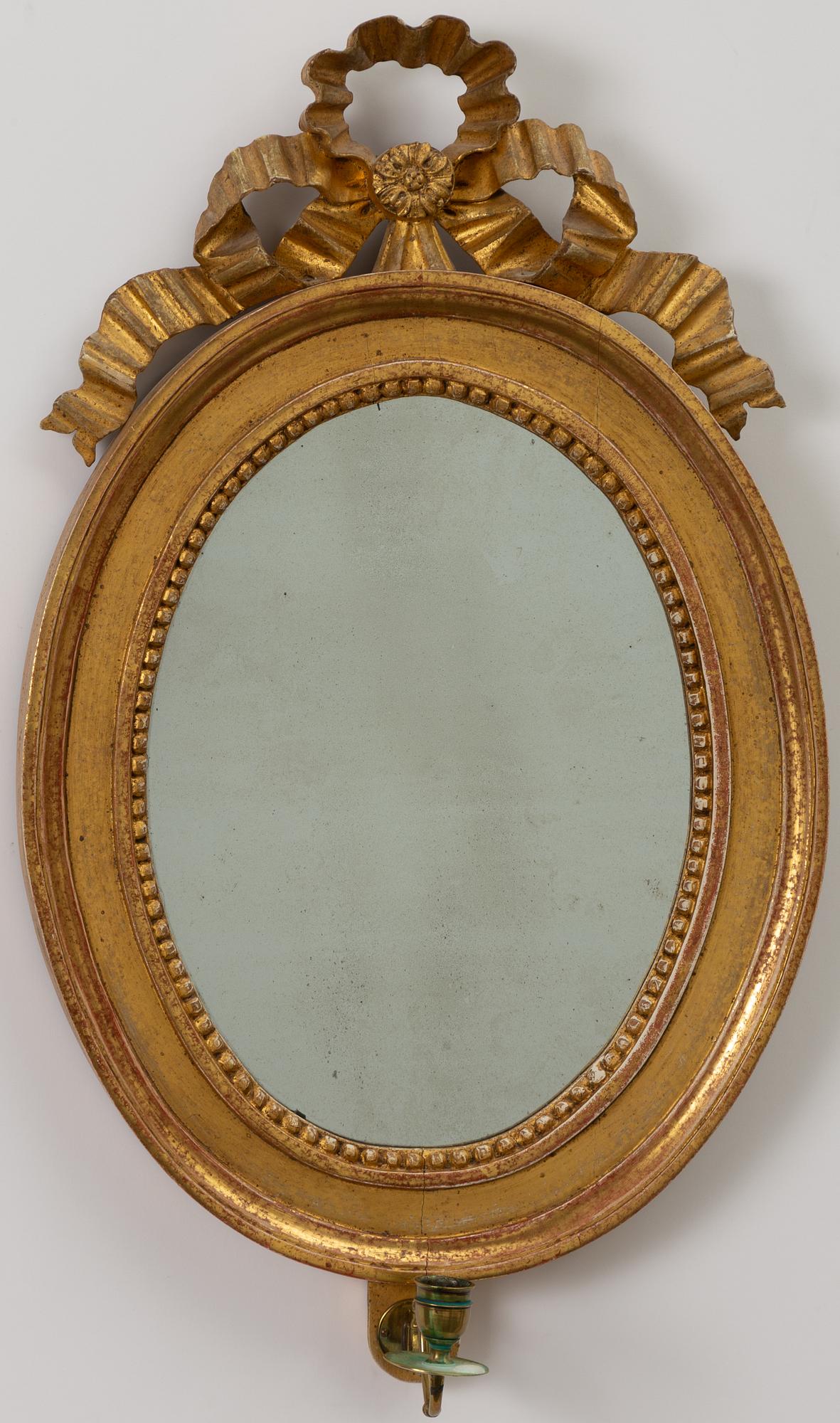 A pair of late Gustavian one-branch giltwood girandole mirrors, Stockholm, circa 1800.