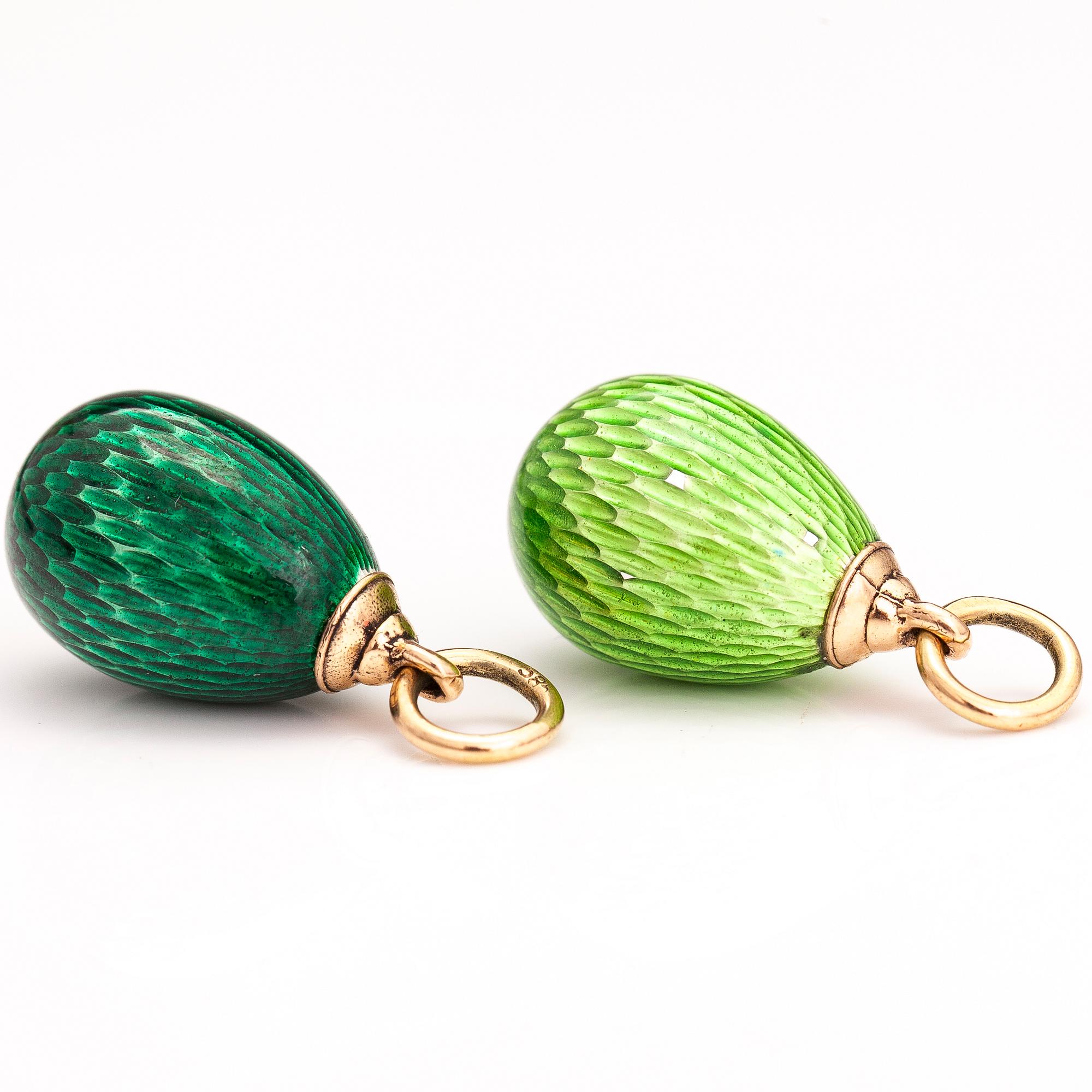 Two 14K gold pendants with enamel.