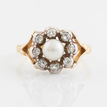 An 18K gold ring and silver set with a pearl and old-cut diamonds.