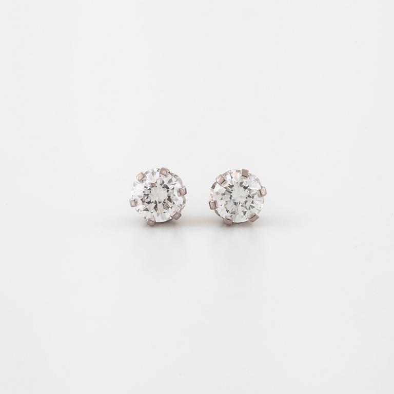 A pair of brilliant cut diamond earrings.