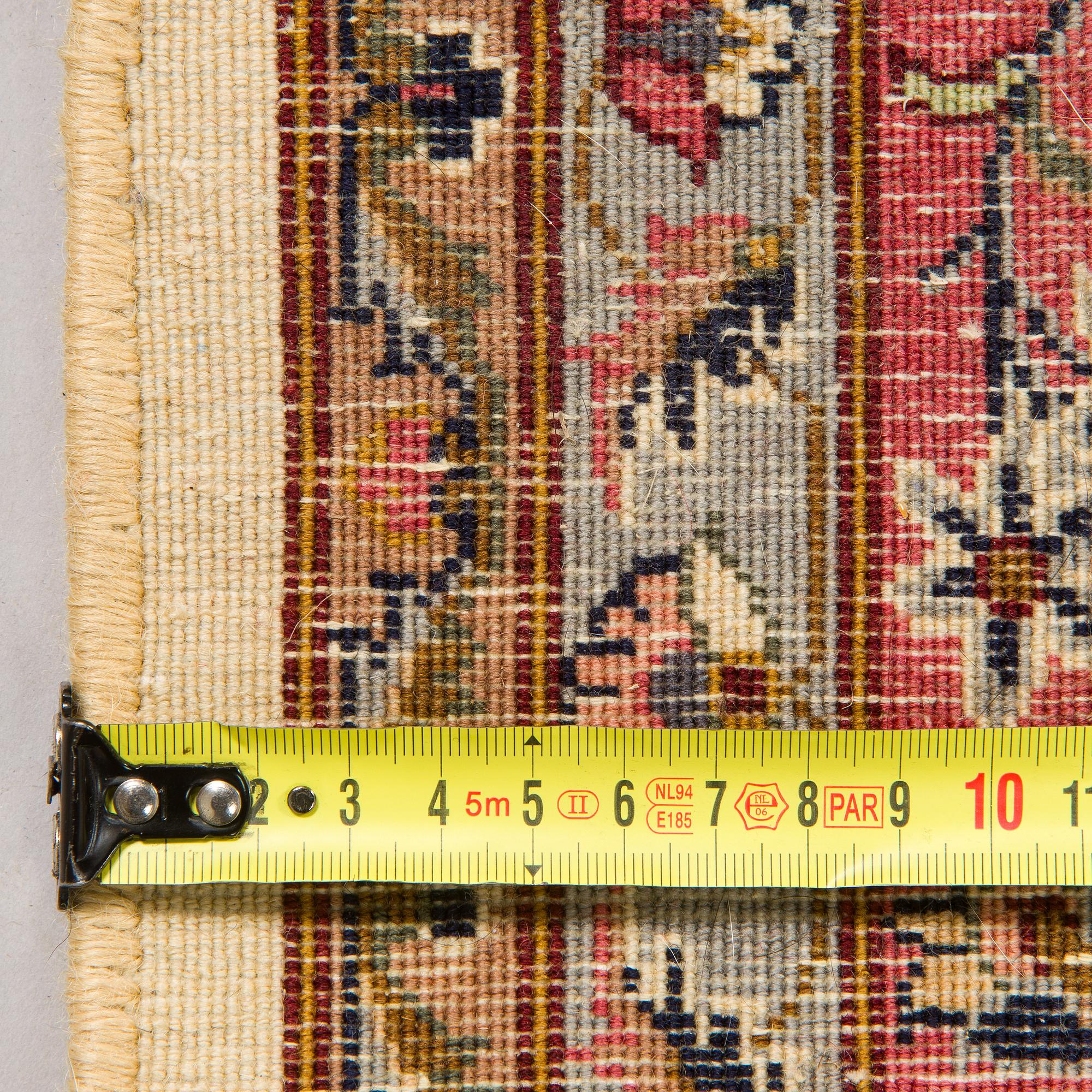 A Tabriz rug, approx. 276 x 183 cm.