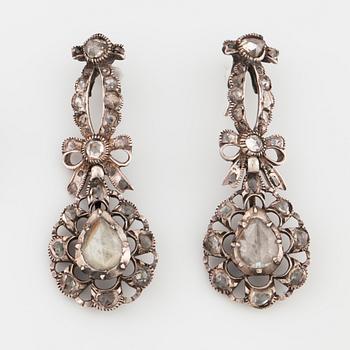 A pair of earrings and a brooch set with rose cut diamonds.