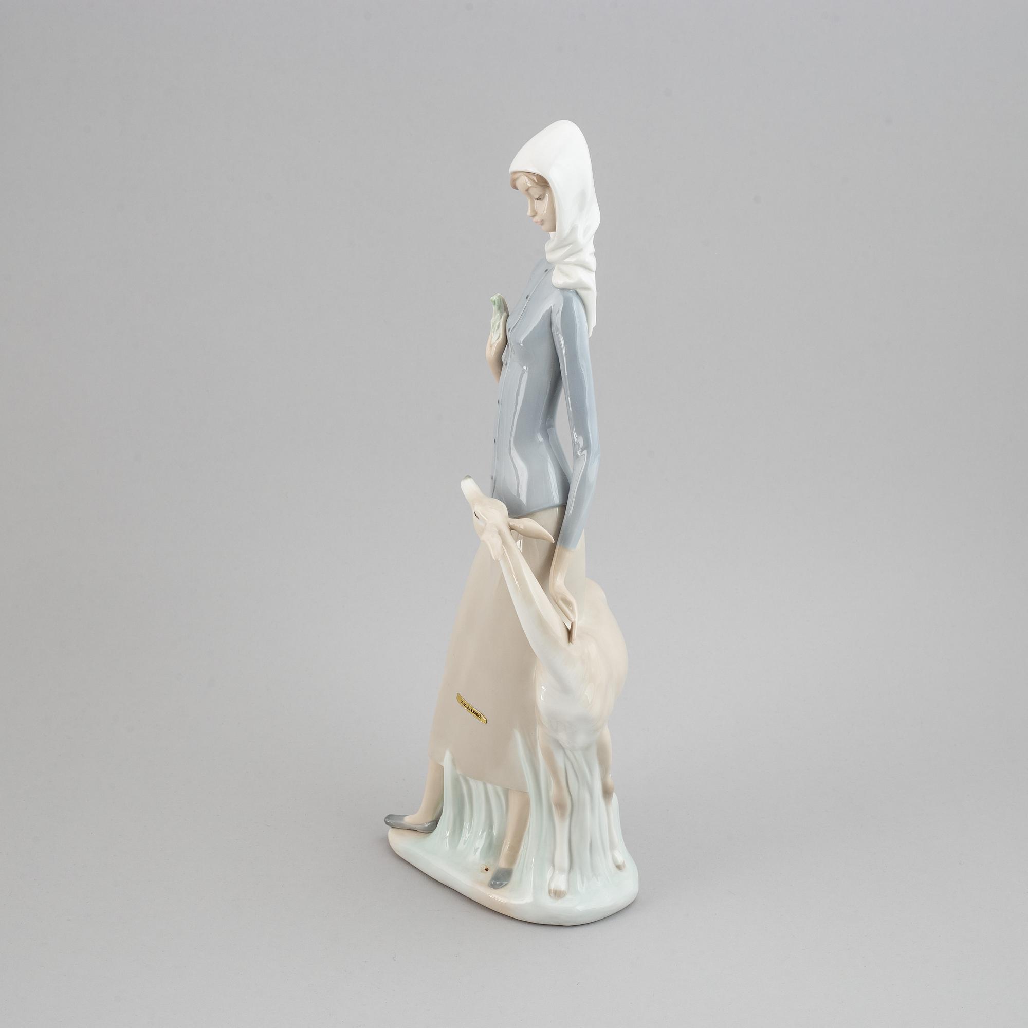 A Lladro porcelain figure of a lady with a dog, Spain, 20th Century.