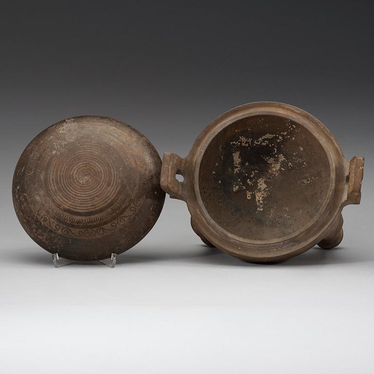 A pottery tripod censer, Han dynasty (206 B.C. -220 A.D.).