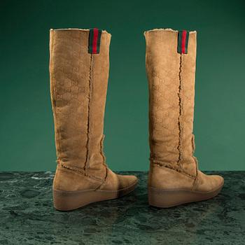 A pair of boots by GUCCI in size 39.