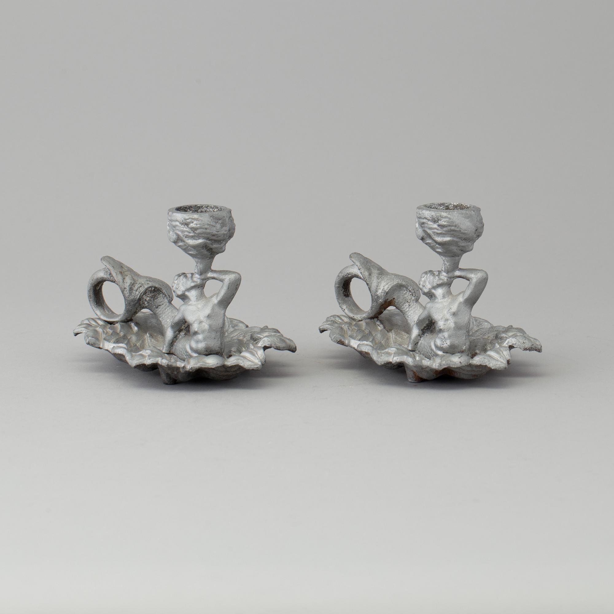 A pair of cast iron candlesticks, marked Verlag bei, A. Meves, Berlin, late 20th century.