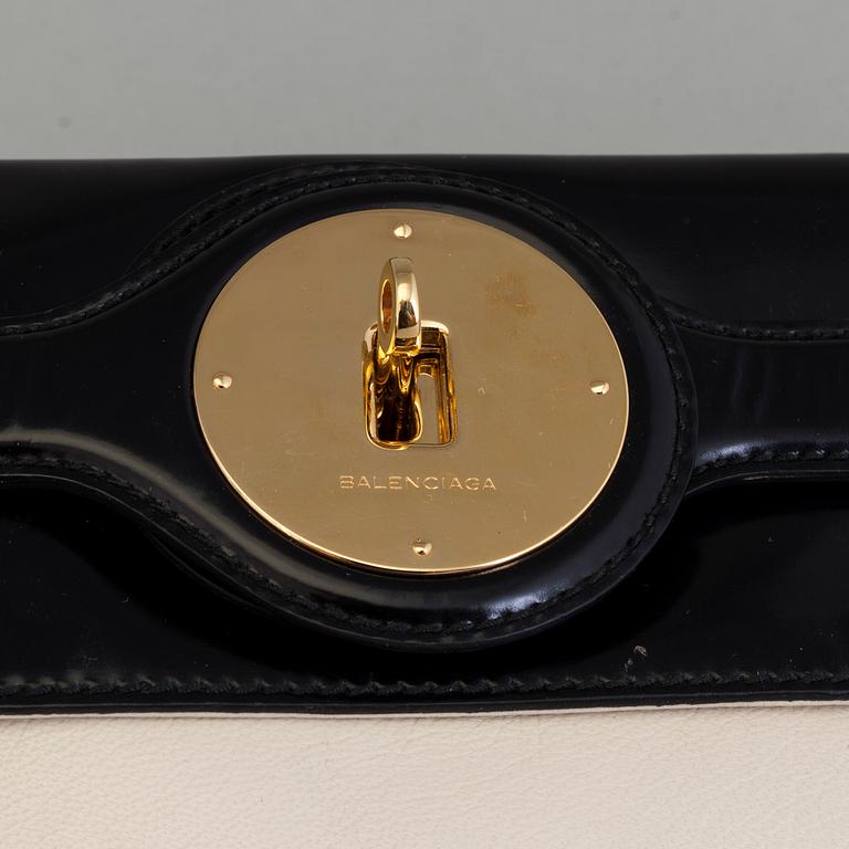 A black and white leather clutch by Balenciaga.