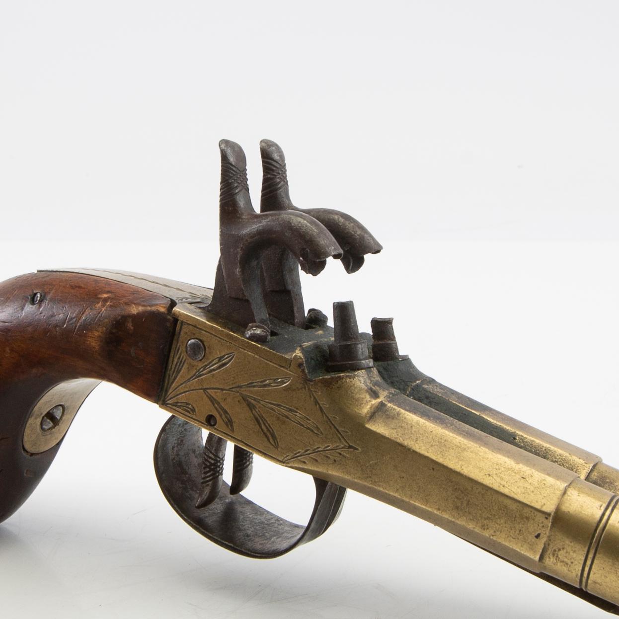 Double-barrel percussion pistol with bayonet, 19th century.