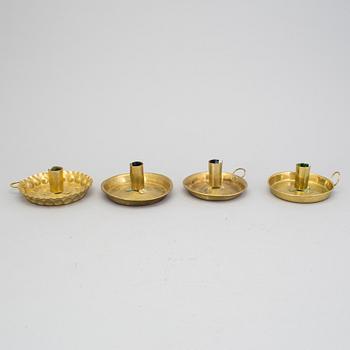 A lot of four brass candle sticks 18/19th century.