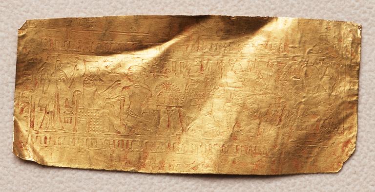 A set of nine presumably modern Egyptian-style gold foil sheets with figures and hieroglyphs.