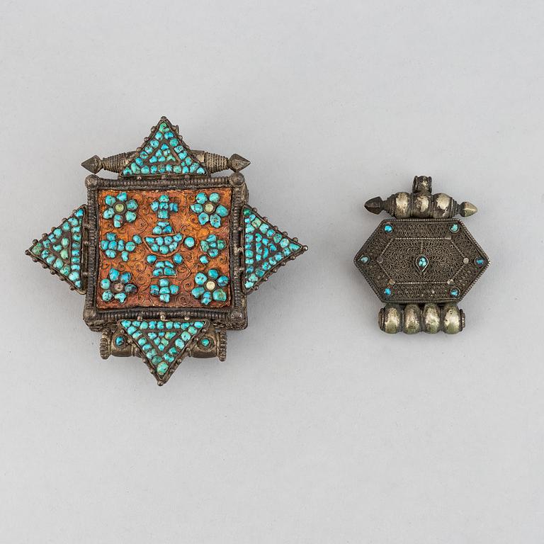 Two metal pendants with turkoise inlay, Tibet, circa 1900.