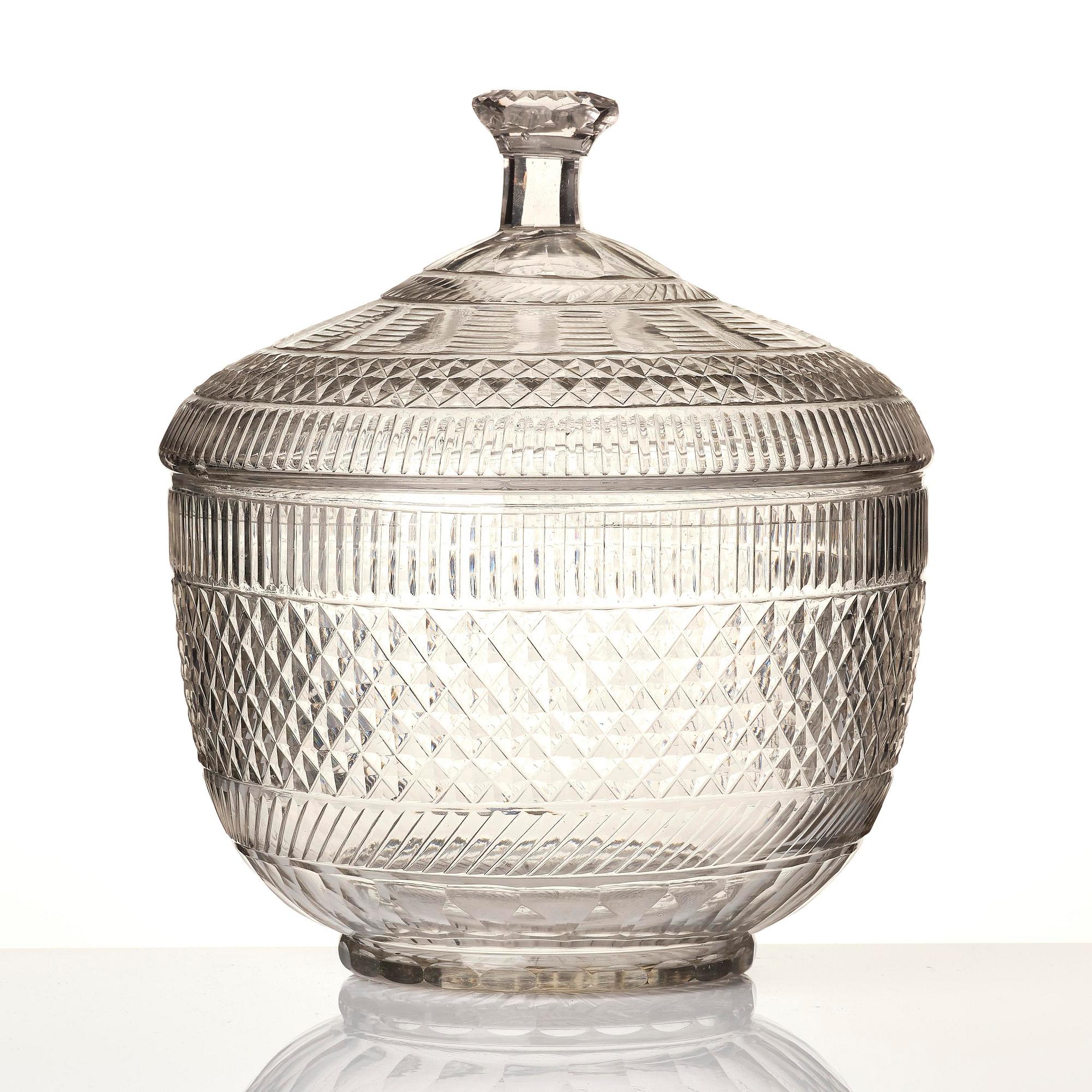 A cut glass punch bowl with cover, stand and ladle, Empire, first part of the 19th century.