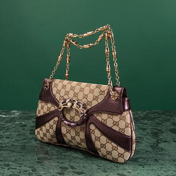 A bag VÄSKA, by Gucci.