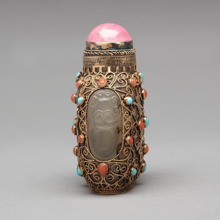 Three nephrite and agathe snuff bottles with stoppers, China and Tibet, late 19th Century.