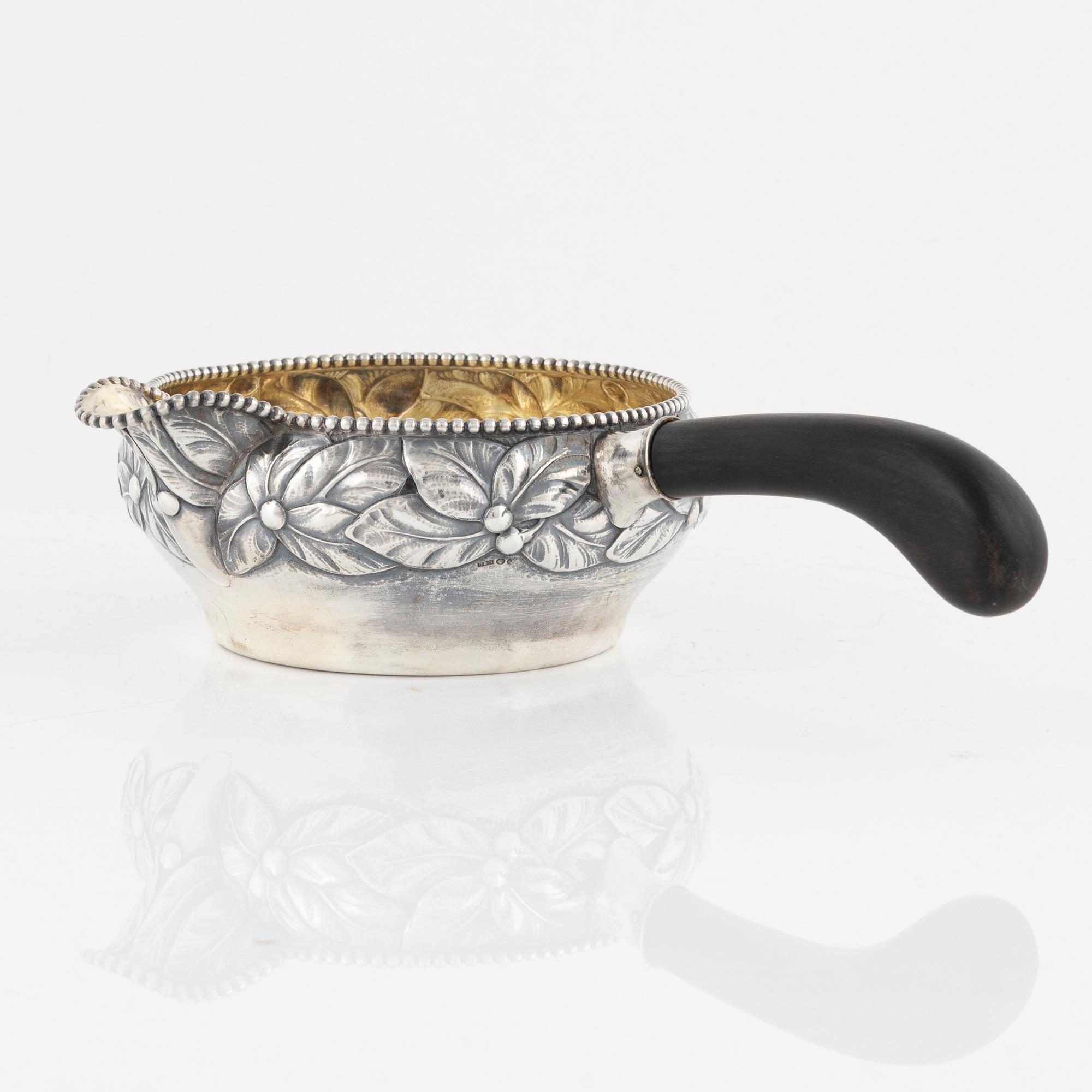 A parcel.gilt sauce dish with handle, Denmark, 1919.