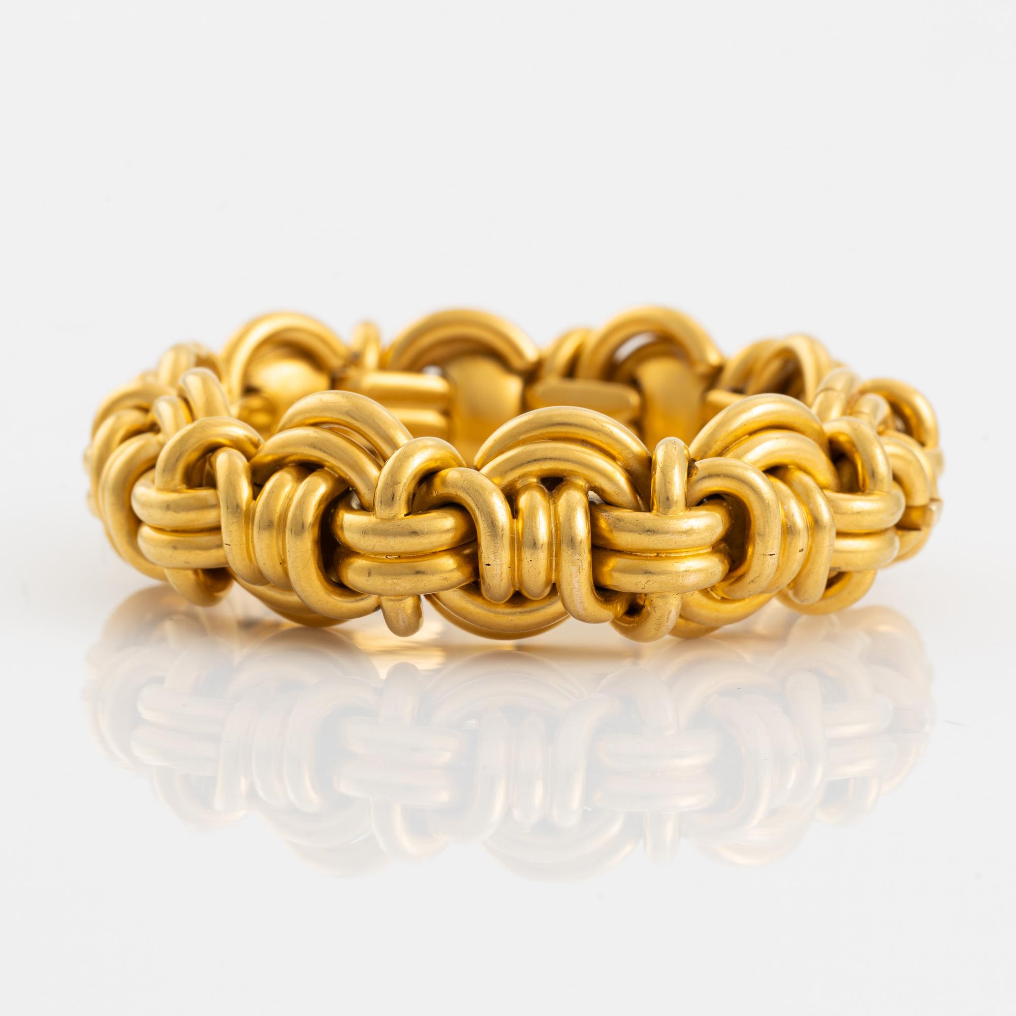 An 18K gold bracelet.