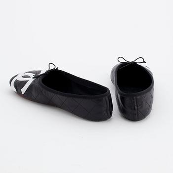 CHANEL, a pair of black leather ballet flats.