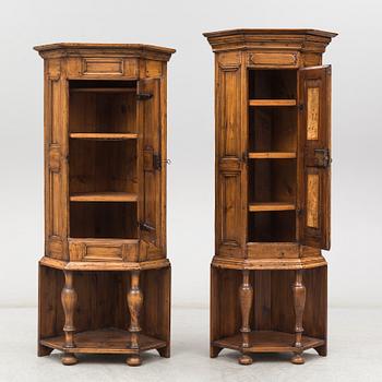 Two 18th century wooden corner cabinets.