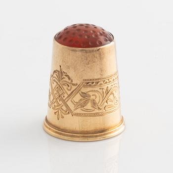 An 18K Gold Thimble with carnelian.
